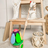 Bajo wooden rainbow flower push along toy leaning on display table 