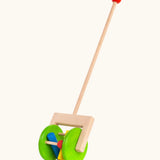 Bajo rattle push along toy showing 2 large green wooden wheels, long handle and 3 coloured cylinder rattles