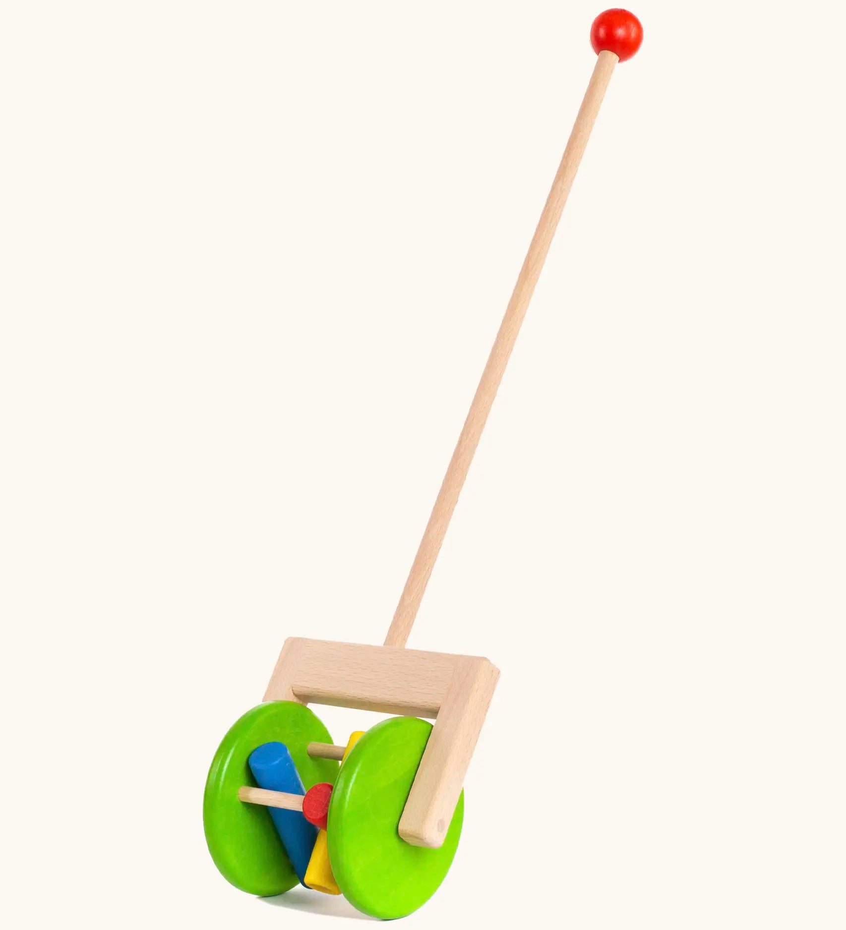 Bajo rattle push along toy showing 2 large green wooden wheels, long handle and 3 coloured cylinder rattles