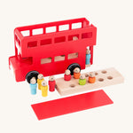 A top view of the Bajo Red London Bus, showing the roof and first floor removed to show how little ones can put the peg doll passengers inside. On a cream background