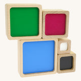 A simple setup made from the Bajo squaremide sensory wooden blocks available at Babipur. Each block is showing its coloured base.