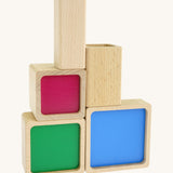 Bajo squaremide sensory stacking toy available at Babipur. 5 wooden square and rectangular shaped blocks with a different coloured base. Each blocks make a different sound.
