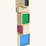 A tower stack made Bajo squaremide sensory wooden blocks available at Babipur. Each block is showing its coloured base.