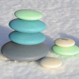 Set of 10 smooth, tactile wooden circular pebbles by Bajo in shades of blue and white, for stacking or small world play, available at Babipur.