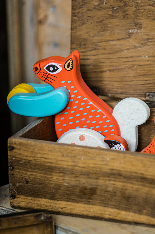 Bajo Tobe Red Jumping Squirrel On Wheels, a wooden rolling squirrel toy, to represent Bajo Tobe Toys for sale at Babipur, Bajo's official UK distributor. 
