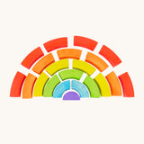 Bajo plastic-free stacking wooden rainbow blocks laid out on a cream background