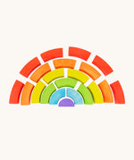 Bajo plastic-free stacking wooden rainbow blocks laid out on a cream background