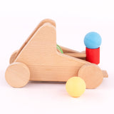 A side image of the A Bajo wooden catapult toy set available available at Babipur showing a ball resting on the red base
