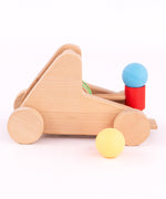 A side image of the A Bajo wooden catapult toy set available available at Babipur showing a ball resting on the red base
