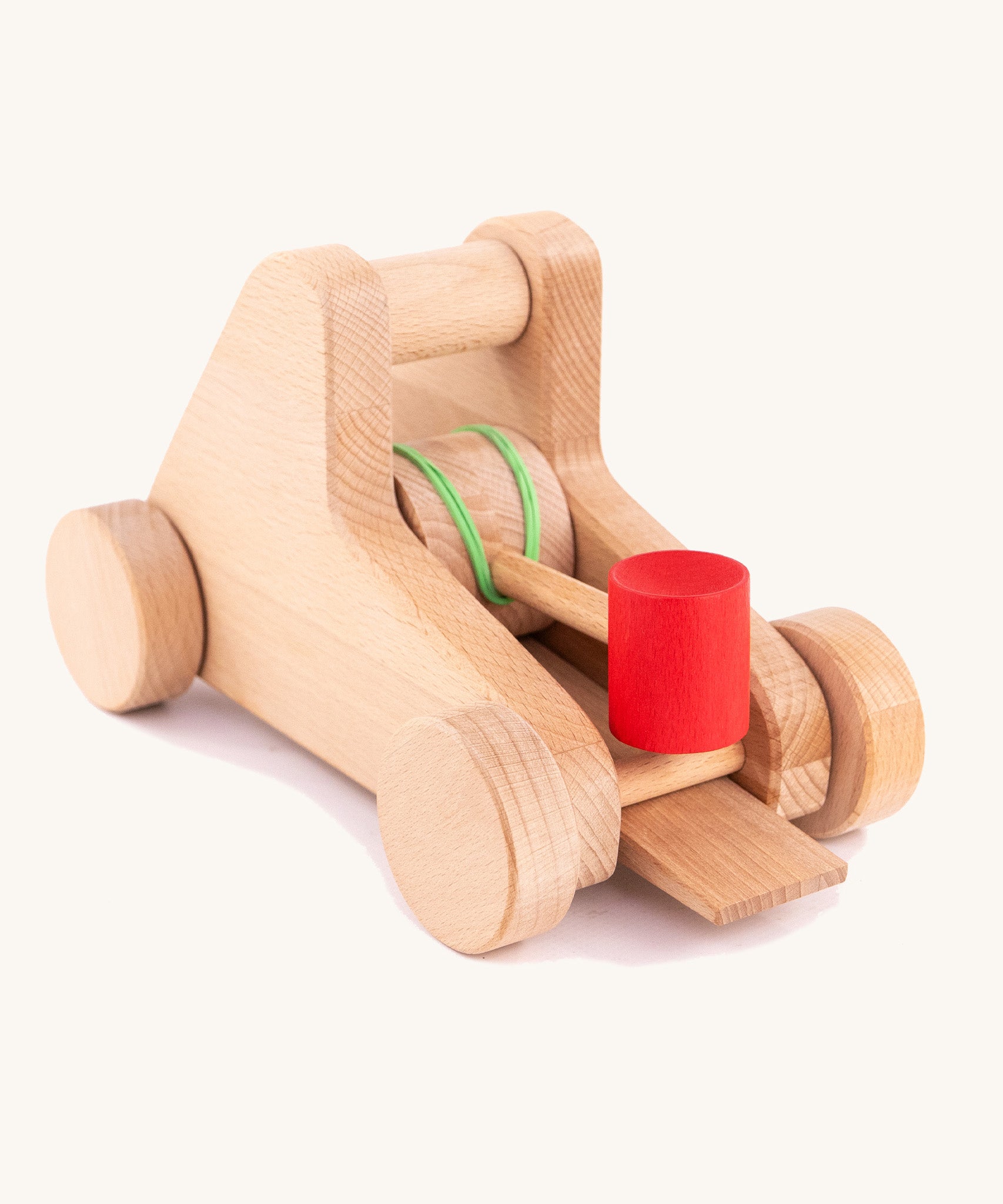 The back of the A Bajo wooden catapult toy set available available at Babipur. showing the elastic pull back system 