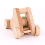 A front view of the A Bajo wooden catapult toy set available available at Babipur showing the elastic catapult system fully pulled back