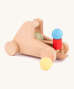 A Bajo wooden catapult toy set available available at Babipur. Set includes 2 wooden balls with a pull back catapult system with wheels