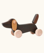 Bajo Dachshund Brown Puppy Push along toy, made from wood, on 4 wheels with floppy ears and a pointed tail.