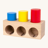 Bajo deep and shallow shape sorter puzzle set available at Babipur. The rectangular shape wooden base has the 3 coloured tubes inside the shallow cut outs