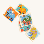 A closer look at 5 square pieces from the kids wooden Bajo Dinosaur Memory Game, showing images of colourful dinosaurs on a cream background