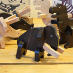 The Bajo Mammoth from the Bajo Puzzle & Sorter - Black Oak Mammoth, with other Bajo Puzzle Sorter figures on a wooden table