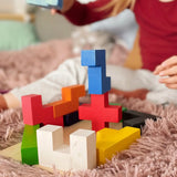 Child building a tower using different Bajo wooden coloured Pentomino puzzle blocks