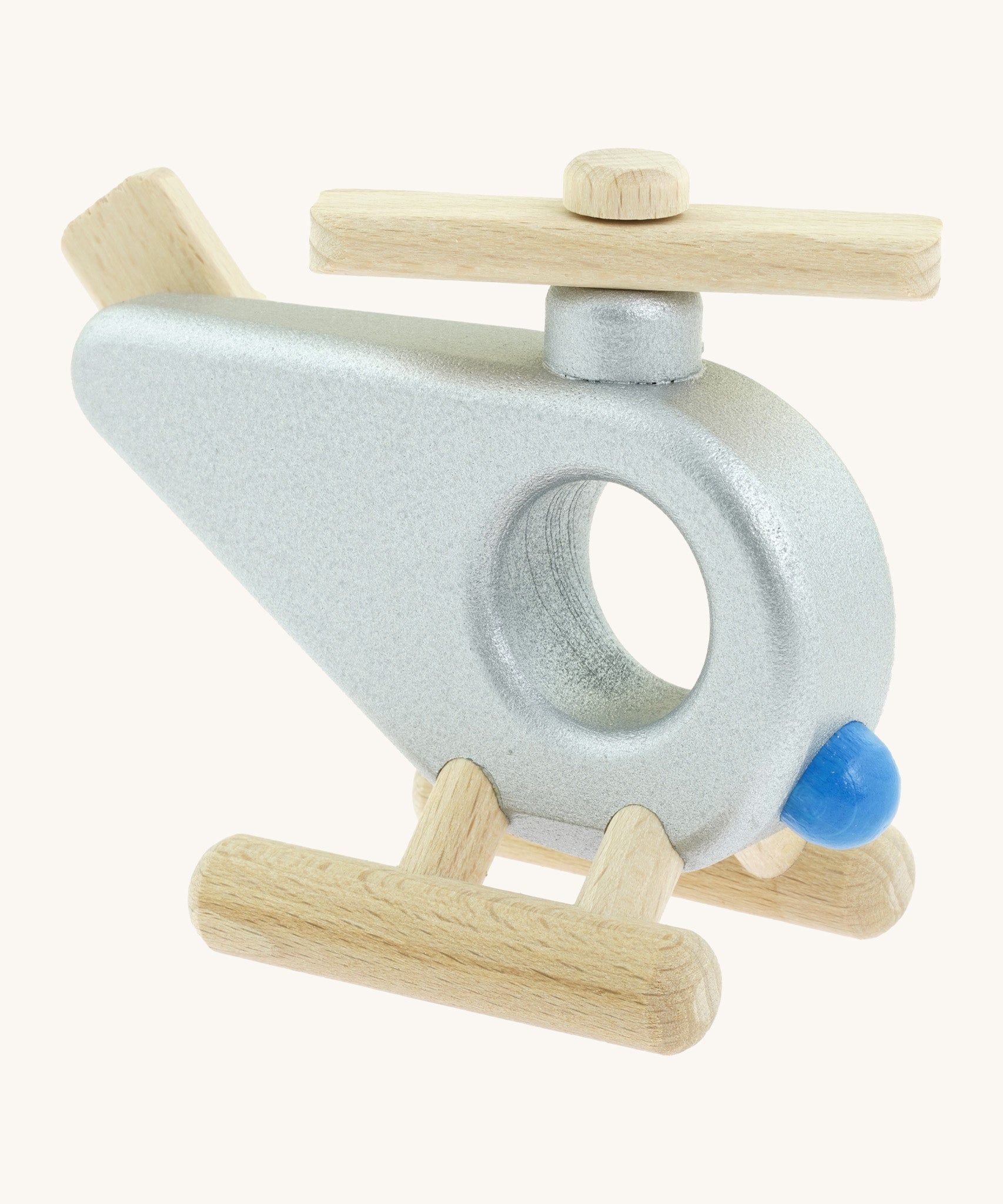 A side photo of the Bajo wooden police helicopter available at Babipur. This helicopter is silver with movable propellors and a circular window 