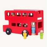 Three wooden peg doll passengers stood outside of the bus, ready to leave and get onto the bus. The image also shows the removable top so children can put the peg dolls on and off the bus. The image is on a cream background