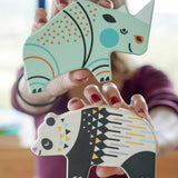 A member of the Babipur team holding up a Bajo rhino and panda Endangered Animals wooden toy figures up to the camera. These heirloom quality toys by Bajo are part of a wide range of wooden toys available here at Babipur.