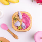 A pink and purple desert with fresh fruit in the Eco Rascals Bamboo Bowl & Spoon Weaning Set in pink silicone.