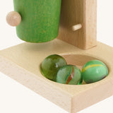 A close up of all 3 marbles in the bottom hole on the base of the Beck coloured roller cup marble run available at Babipur 