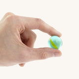 A close up of the marble from the Beck coloured roller cup marble run set available at Babipur showing scale