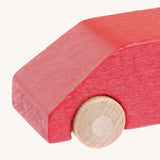 A close up of the Beck wooden van toy in red available at Babipur showing the wheel detail