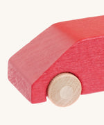 A close up of the Beck wooden van toy in red available at Babipur showing the wheel detail