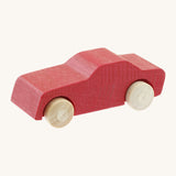 Beck wooden toy passenger car available at Babipur. This vehicle has a red body and unpainted wheels