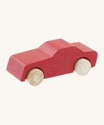 Beck wooden toy passenger car available at Babipur. This vehicle has a red body and unpainted wheels