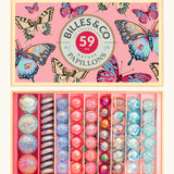 Billes & Co butterfly anamorphic marble set presented in a butterfly decorated box. Showing 71 different sized marbles in bright pastel colours