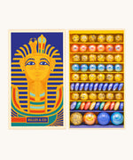 Billes & Co Toutankhamon marble set available at Babipur. A box of 62 marbles and pebbles in Pharaoh inspired colours. Set comes in a cardboard box with a Pharaoh on the front.