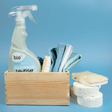 Bio-d 500ml all purpose sanitiser spray in fragrance free sitting inside a wooden caddy with other cleaning products. This sanitiser spray is available at Babipur