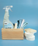Bio-d 500ml all purpose sanitiser spray in fragrance free sitting inside a wooden caddy with other cleaning products. This sanitiser spray is available at Babipur