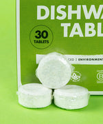 A close up of 3 Bio-D dishwasher tablets, showing the water soluble film holding the tablet. These dishwasher tablets are available at Babipur.
