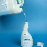 A 5L bottle of Bio-D all purpose sanitiser refill in fragrance free being poured into a 500ml bottle, both available at Babipur.