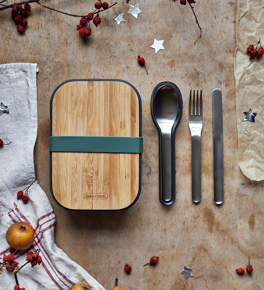 Black + Blum stainless steel cutlery set with portable hygienic carry case resting next to a olive original lunhcbox.