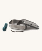 Black+Blum Large Leak Proof Stainless Steel Lunch Box with ocean blue coloured strap. The lid is shown resting on the side of the lunchbox with the strap and fork besides it. This lunchbox is part of a wide range of stainless steel lunch box options available here at Babipur. 