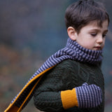 A child outside wearing the LGR lovely Dreamy Blue Stripe scarf and mittens