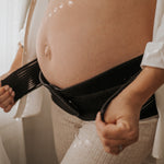 A closer look at the Lola & Lykke Core Relief Pregnancy Support Belt, being worn under a pregnancy bump