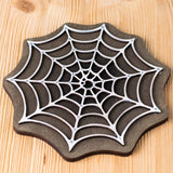 Bumbu handmade and hand painted white cobweb piece on a black back piece available at Babipur ideal for a spooky playscene