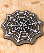 Bumbu handmade and hand painted white cobweb piece on a black back piece available at Babipur ideal for a spooky playscene