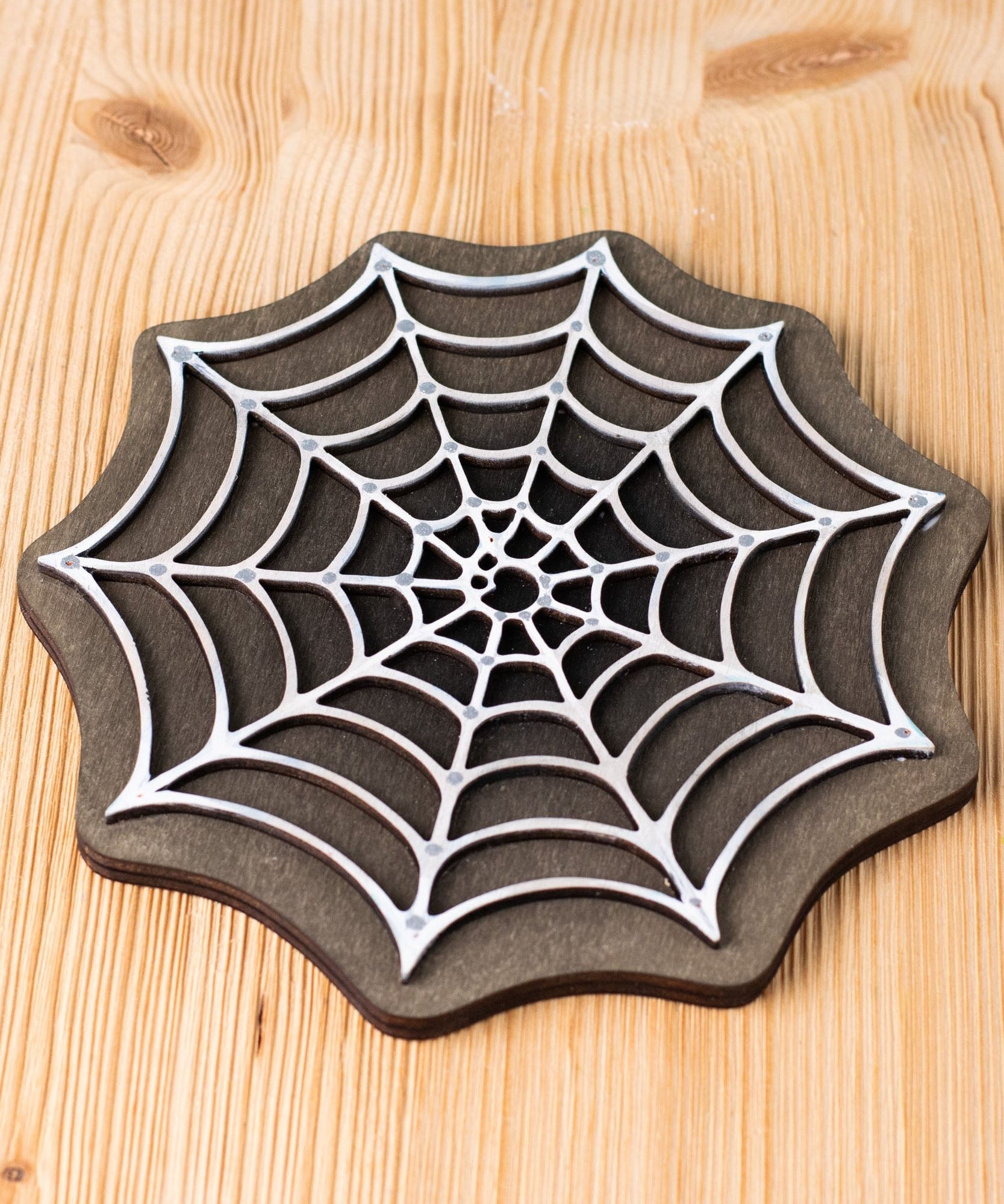 Bumbu handmade and hand painted white cobweb piece on a black back piece available at Babipur ideal for a spooky playscene