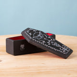 A Bumbu handmade and hand painted wooden black coffin with white detail and red inside with a removable lid available a Babipur.