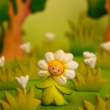 Bumbu wooden daisy flower child figure with standing next to wooden flowers in a playscene