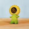 Bumbu handcrafted wooden sunflower figure with hand painted facial features standing on a wooden surface