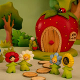 Bumbu wooden flower children standing in front of a wooden strawberry house and trees