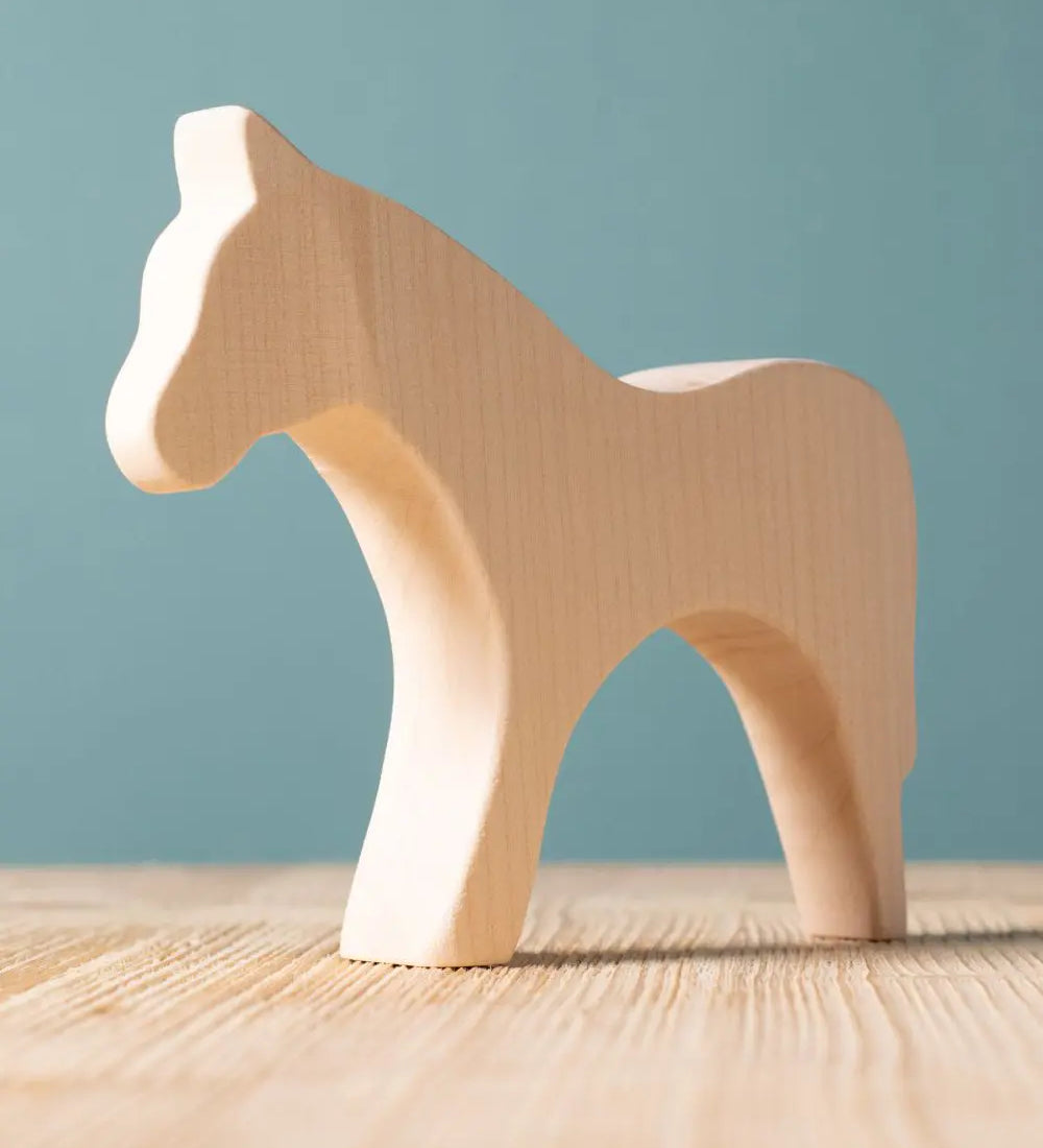 Bumbu paint your own wooden toy horse. A smooth and natural finish with wood grain showing.