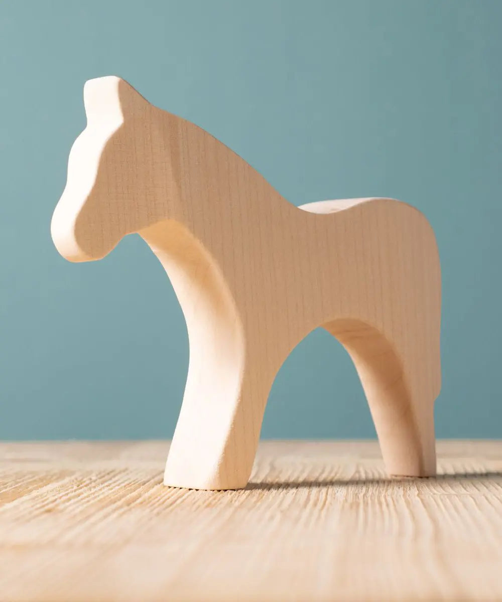 Bumbu paint your own wooden toy horse. A smooth and natural finish with wood grain showing.